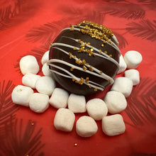 Load image into Gallery viewer, Ralph's Chocolate Delights Gourmet on Red Background Large Hot Chocolate Bombs Size (Approx.): Large 3" x 3" x 3" One Large Hot Chocolate Bombs makes approximately one large cup of hot cocoa A delicious dessert, and addition to dinner parties, Christmas, Holidays, Birthdays, Gifts Ingredients Premium Ghirardelli ChocolateMarshmallowsSalted Caramel Hot Chocolate Mix Caramel Sauce Dulce De Leche